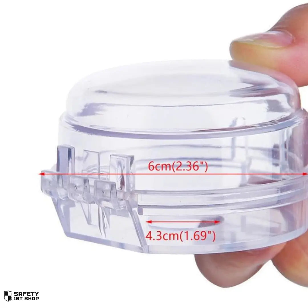 Clear stove safety knob cover held by fingers – dimensions visible on white background