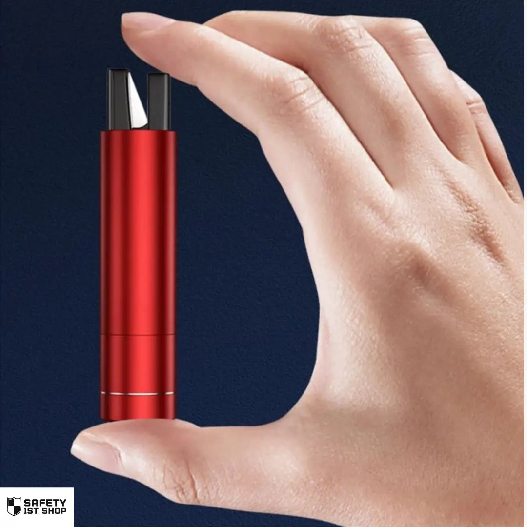 Compact red emergency hammer held between thumb and index finger for size demonstration