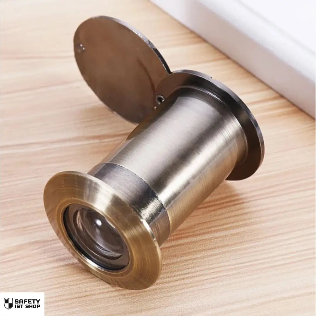 Close-up of door viewer in Qinggu color – light silver-bronze metallic finish on beige laminated surface, subtly glossy and elegant