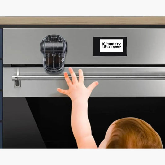 Baby reaching for oven door – safety latch prevents opening for child protection