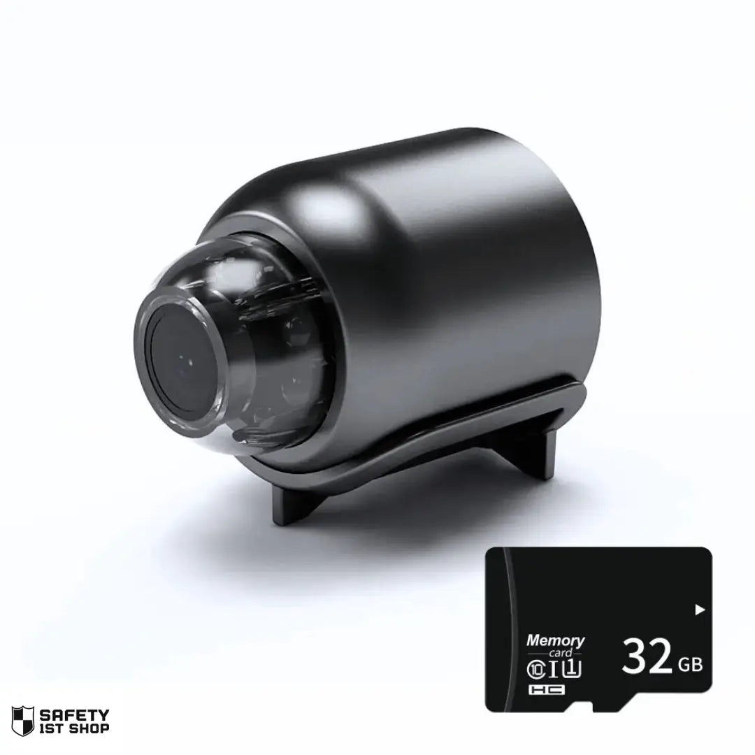 Miniature black surveillance camera displayed on white background, paired with a 32GB black memory card positioned at the bottom right corner.