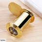 Close-up of luxurious gold door viewer on beige laminated surface, elegant appearance and fine details visible