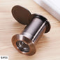 Close-up of door viewer in Honggu color – dark silver-bronze metallic finish on beige laminated surface, elegant and premium