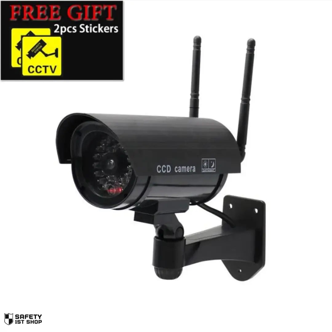 Realistic black dummy surveillance camera with wall mount, presented on white background with free security stickers included