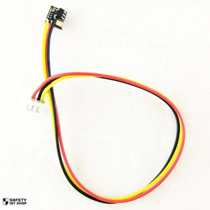 Mini surveillance camera with red, black, and yellow cables displayed on white background