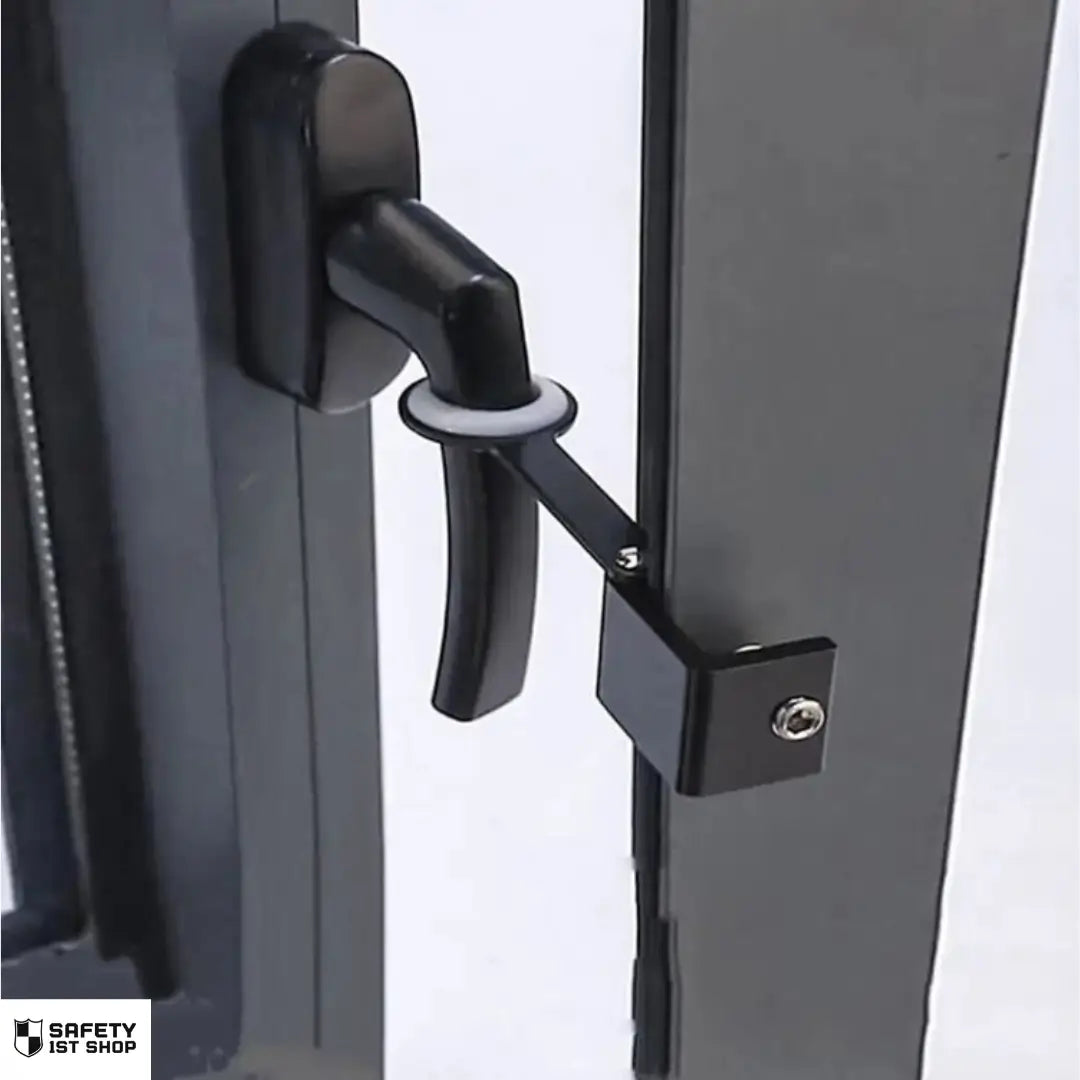 Black window safety lock secured to window handle, preventing full window opening for enhanced security